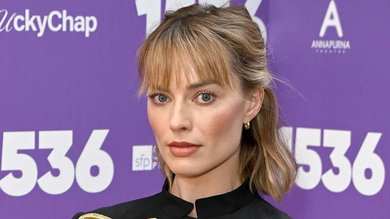 Margot Robbie in a black shirt