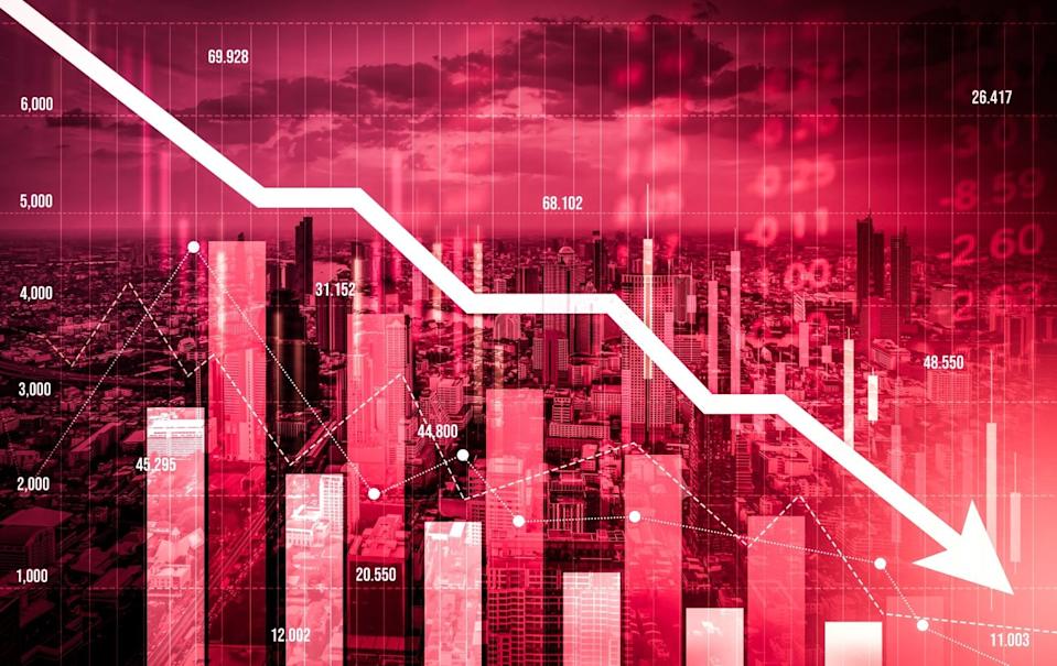 A vivid red-hued image of a city skyline at dusk, overlaid with a large white downward-pointing arrow and financial bar charts. The graph shows various numerical data points such as 69.928, 31.152, 20.550, and 11.003, emphasizing a severe market drop.