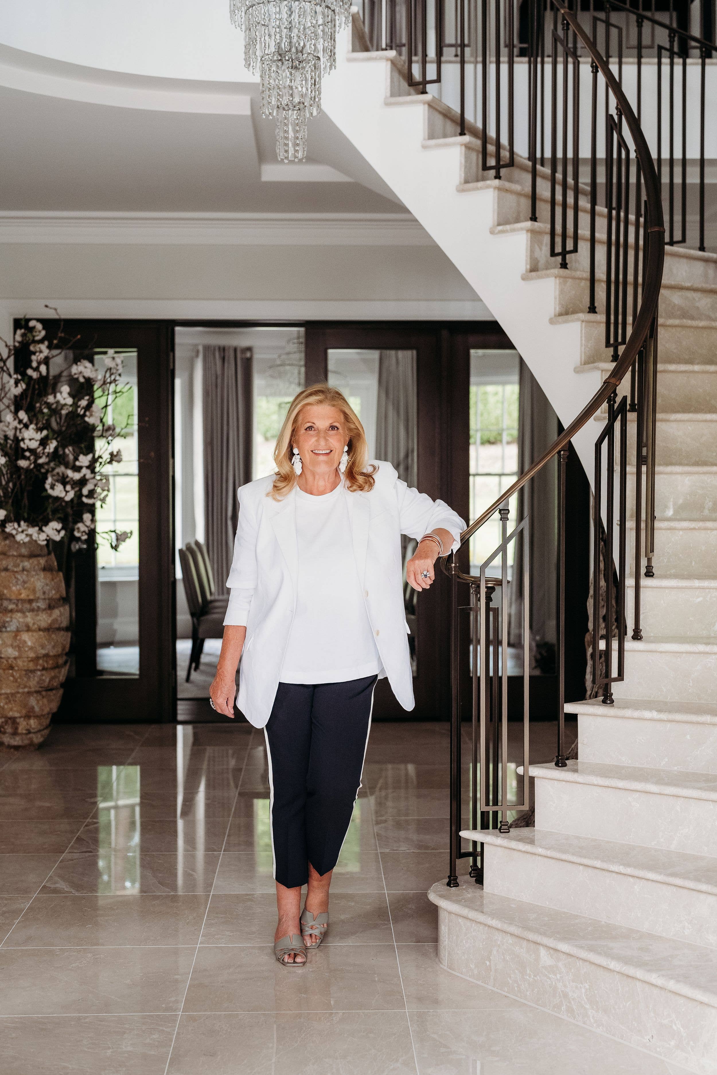 woman in smart clothes at the foot of the stairs 