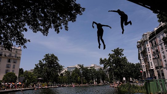Parisians bath in the Canal Saint-Martin in Paris on Tuesday.