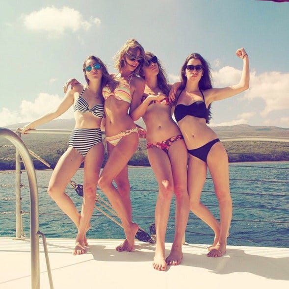 a group of women posing for a photo on a boat a group of women posing for a photo on a boat