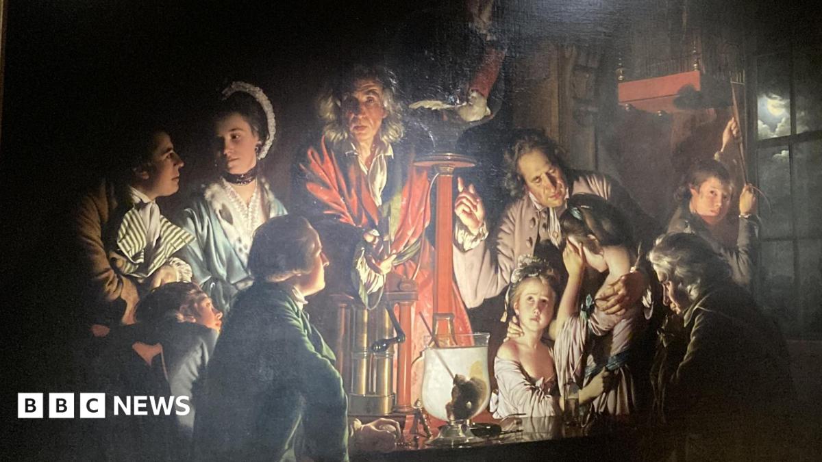 A painting by Derby Artist Joseph Wright features a group of people lit by candelight looking at an experiment on a bird in an air pump.