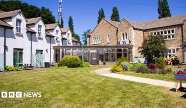 Exterior image of a hospice building set in landscaped gardens.
