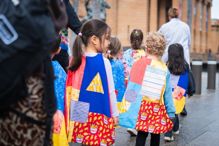preschool students at Art Gallery of NSW wearing super hereo capes and surrounded by art