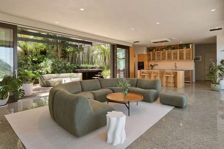 Jenene Crossan and Scottie Chapman are selling their luxury seven-bedroom beach escape at 27 Glenesk Road, above Piha’s Lion Rock, on Auckland's west coast. Photo / Supplied