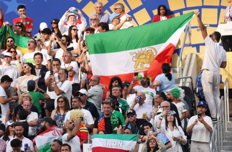 LOS ANGELES, CALIFORNIA - JUNE 15: Fans of IR Iran hold up the nations flag before the FIFA World Cup 2026 Group G match between IR Iran and New Zealand at Los Angeles Stadium on June 15, 2026 in Los Angeles, California. Jamie Squire/Getty Images/AFP (Photo by JAMIE SQUIRE / GETTY IMAGES NORTH AMERICA / Getty Images via AFP)