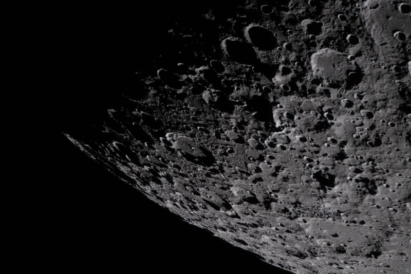 A piece of the lunar surface, seen from orbit, showing heavily cratered terrain.
