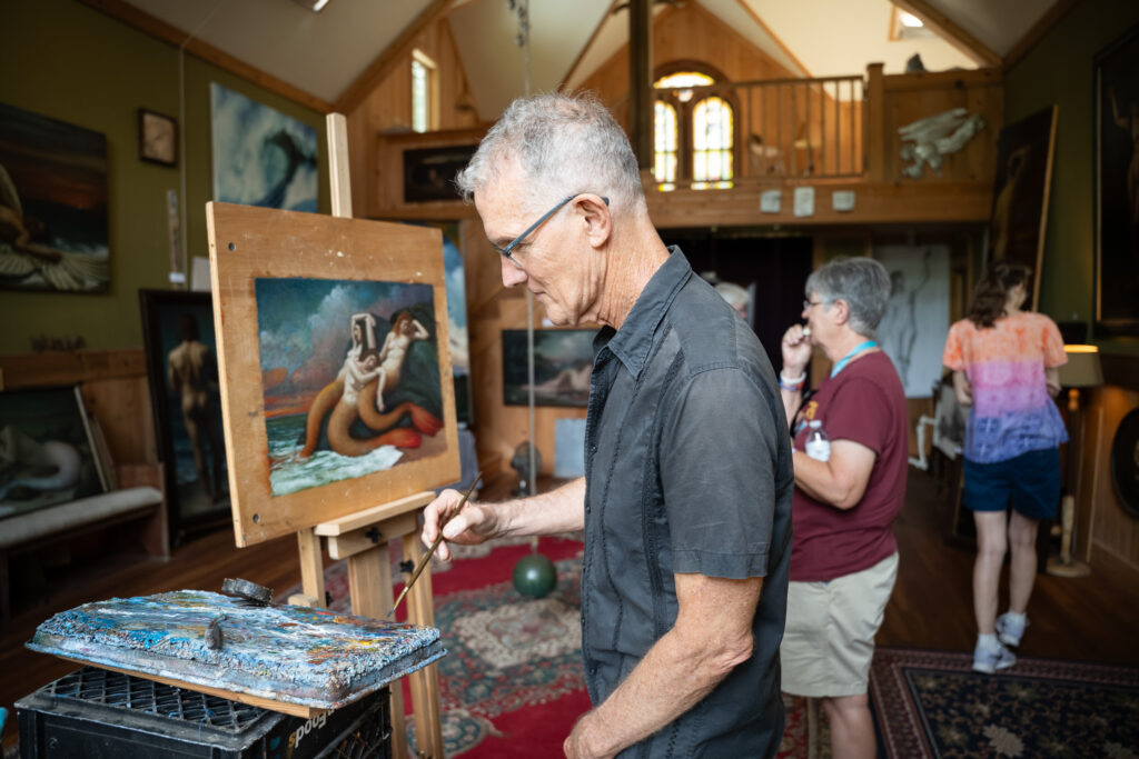 Anthony Ackrill (Painter) painting in his studio during his studio tour.