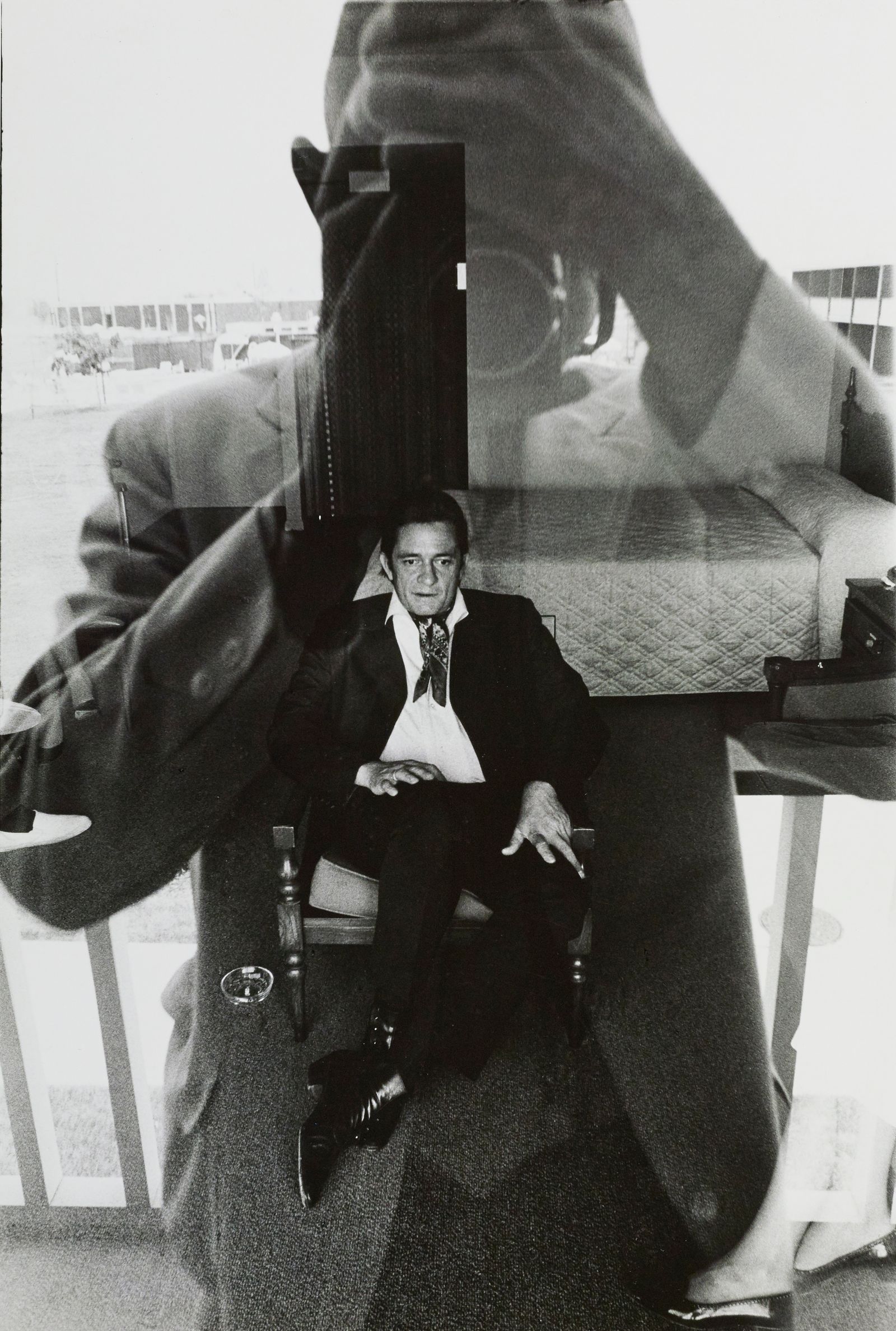 Image may contain Ahmet Nazif Zorlu Clothing Formal Wear Suit Face Head Person Photography Portrait and Coat