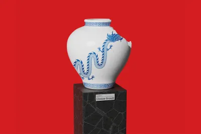 A studio shot of an artifact displayed on a black, textured stone pedestal against a solid red background. The artifact is a white porcelain vase with a cracked glaze texture and a large, serpentine blue dragon painted on its side. Geometric blue patterns decorate the rim and base of the vase. A large chunk is missing from the upper right side of the vessel, showing a broken edge. The front of the pedestal features a small white label that reads "EXHIBIT 4: Chinese Growth".