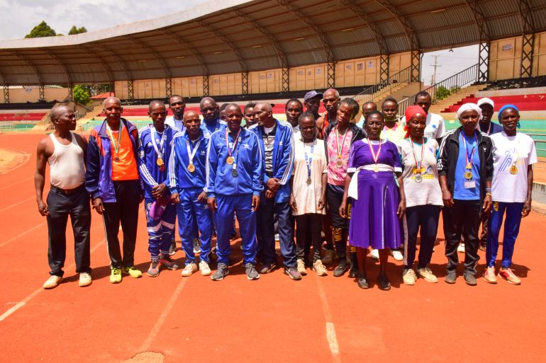 Masters athletes in Meru stretch together before a morning session, turning a dusty village field into an informal training ground for seniors.