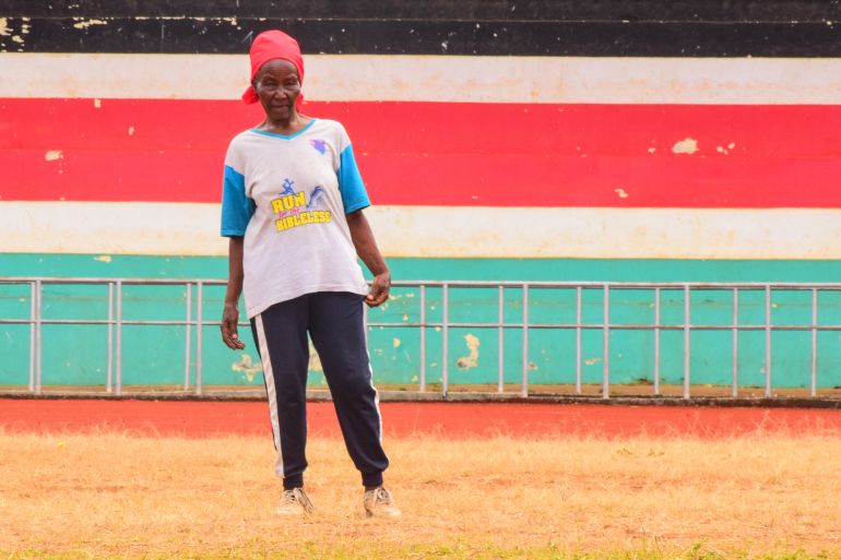 An 82-year-old runner warms up on a red-earthed road in Meru County, where older athletes train three times a week to stay fit and independent.