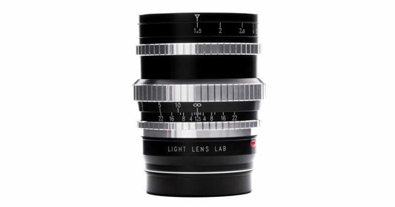 A black and silver camera lens with focus and aperture rings, engraved distance and f-stop markings, and "LIGHT LENS LAB" text on the lower part, shown against a white background.