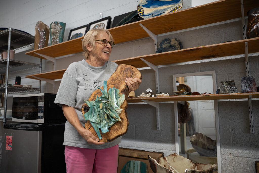 Dorota Haman (Potter, Ceramist) showing one of her favorite pieces in her studio.