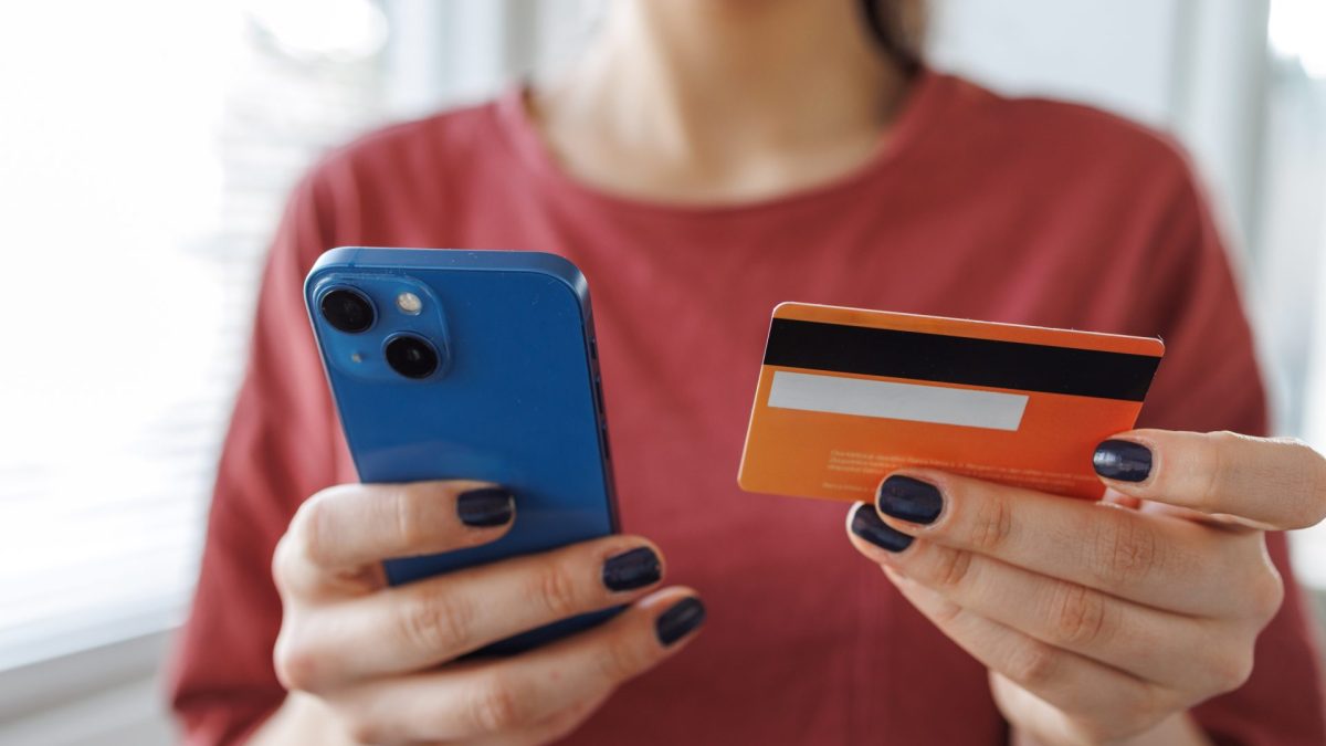 Young woman making a payment with a credit card - stock photo