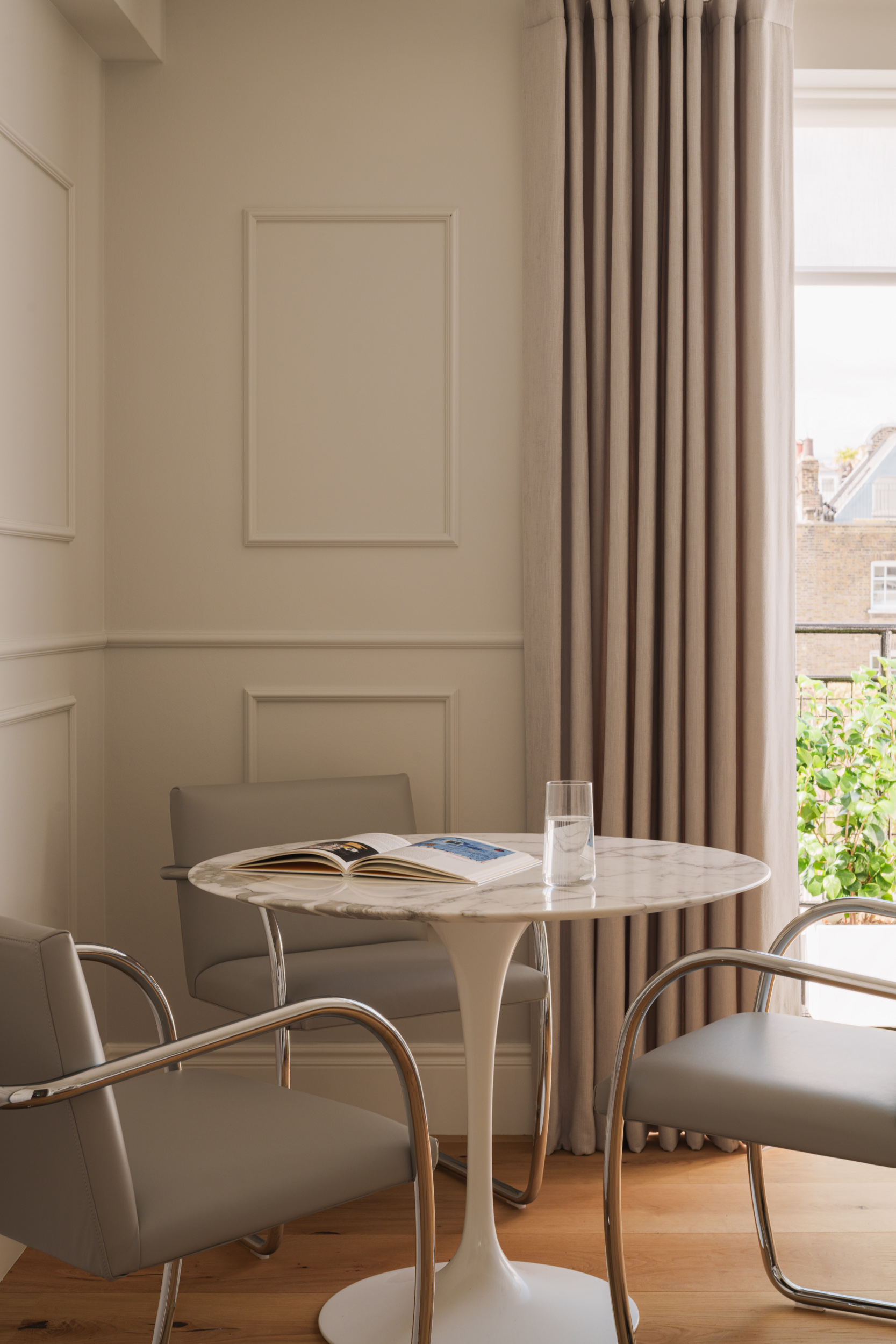 A Scandi-inspired dining room with Saarinen table and curved chairs