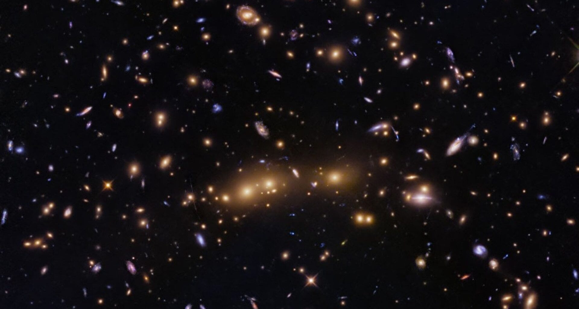 This NASA Hubble Space Telescope image features a swarm of galaxies in the galaxy cluster called CL0016+1609 or MACS J0018.5+1626. Credit: NASA/ESA/STScI/H. Ebeling/D. Coe/G. Kober