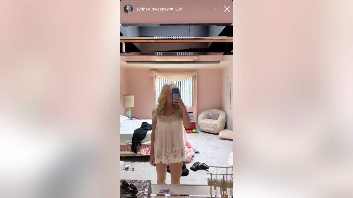 A mirror selfie of Sydney Sweeney in white negligee
