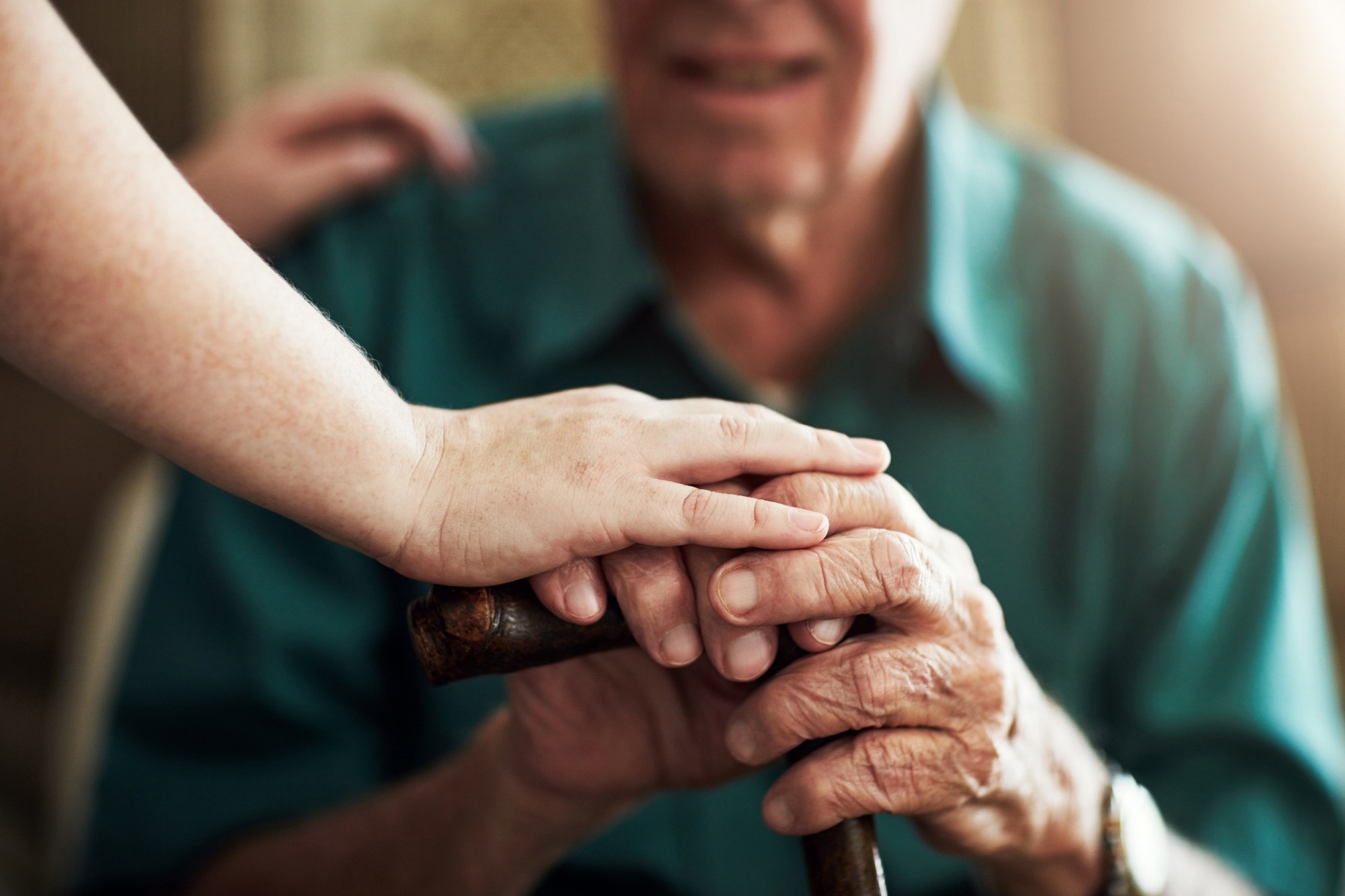 Hands, elderly man and woman in nursing home with support for retirement, assisted living and alzheimer care. Female caregiver, senior patient and touch with kindness for trust, healthcare and help