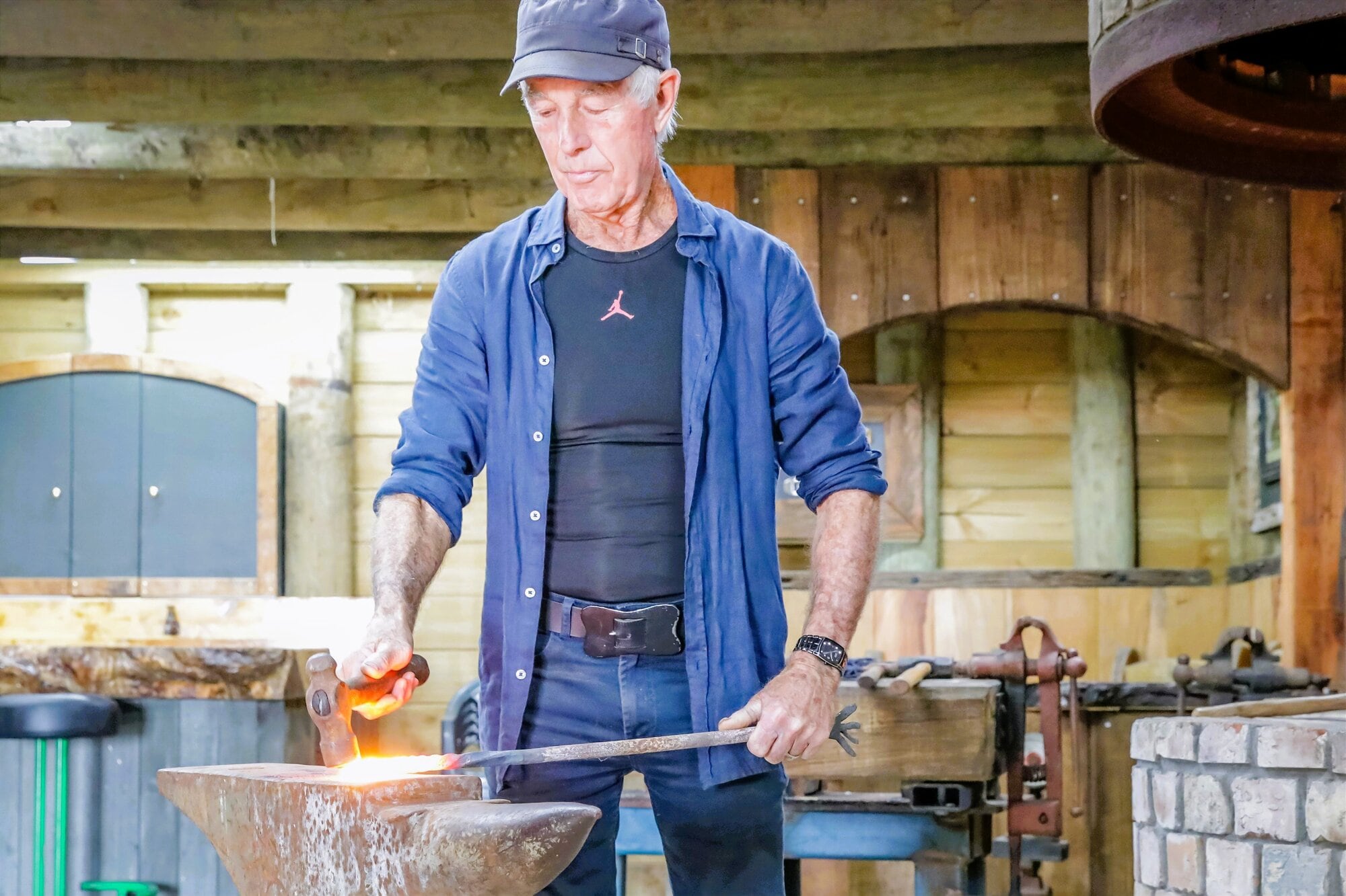  John Carmichael at work in the blacksmith area of the cave. Photo / Kelly O’Hara