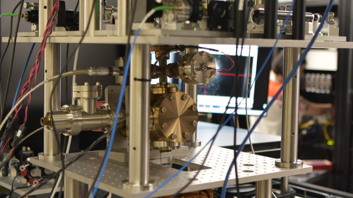 Image of a complicated set of wires, structural elements, and lenses.