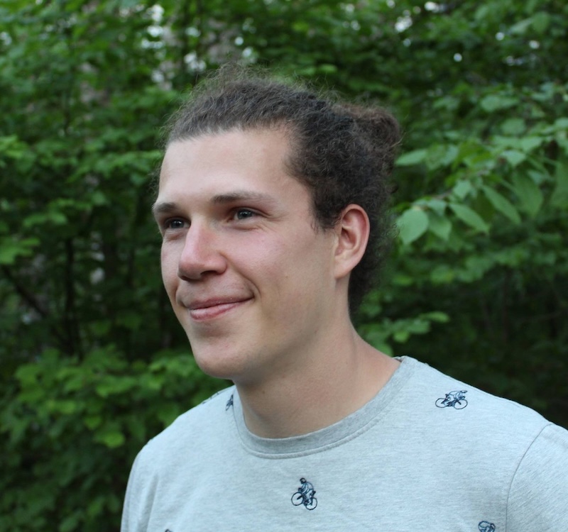 Smiling man wearing a t-shirt with bicycles on it.