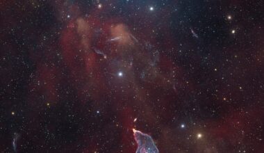 A delicate nebula in shades of blue and purple
	  shines in front of a dark field of stars.
	  The shape of the nebula resembles a mermaid.
