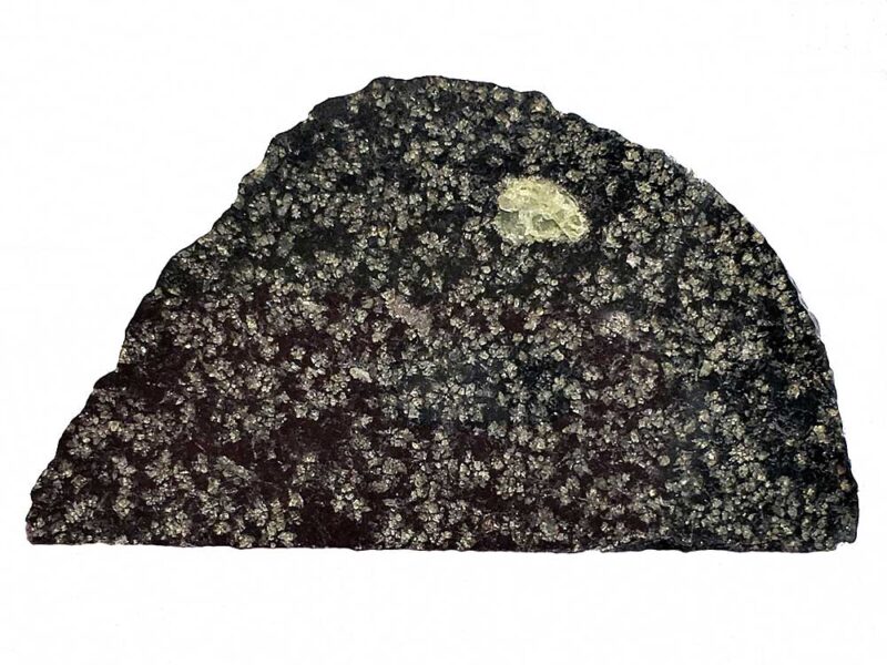 Portion of a black rock with a white crystalized spot.