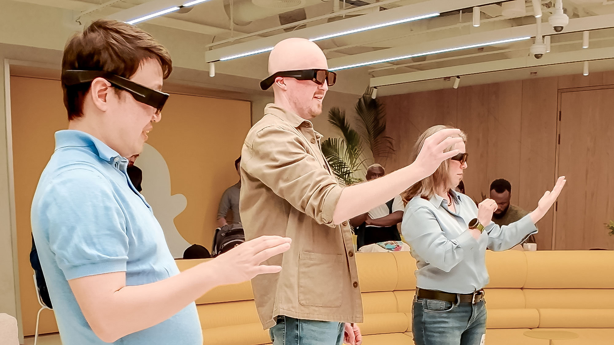 Snapchat Spectacles being worn on person playing around with others in an office space