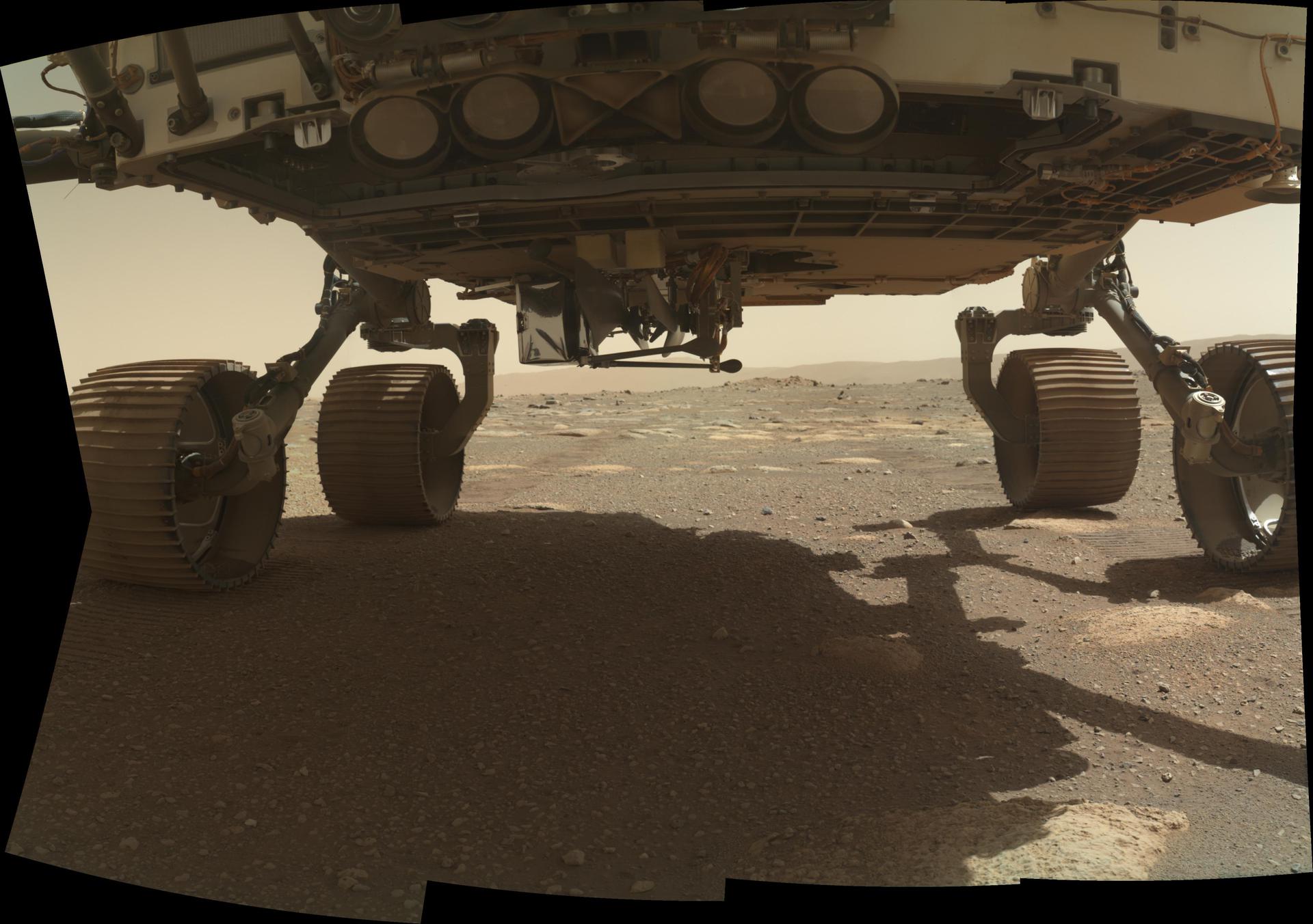 NASA's Ingenuity helicopter can be seen on the belly of the Perseverance rover, ready to be dropped off at the helicopter's deployment location.