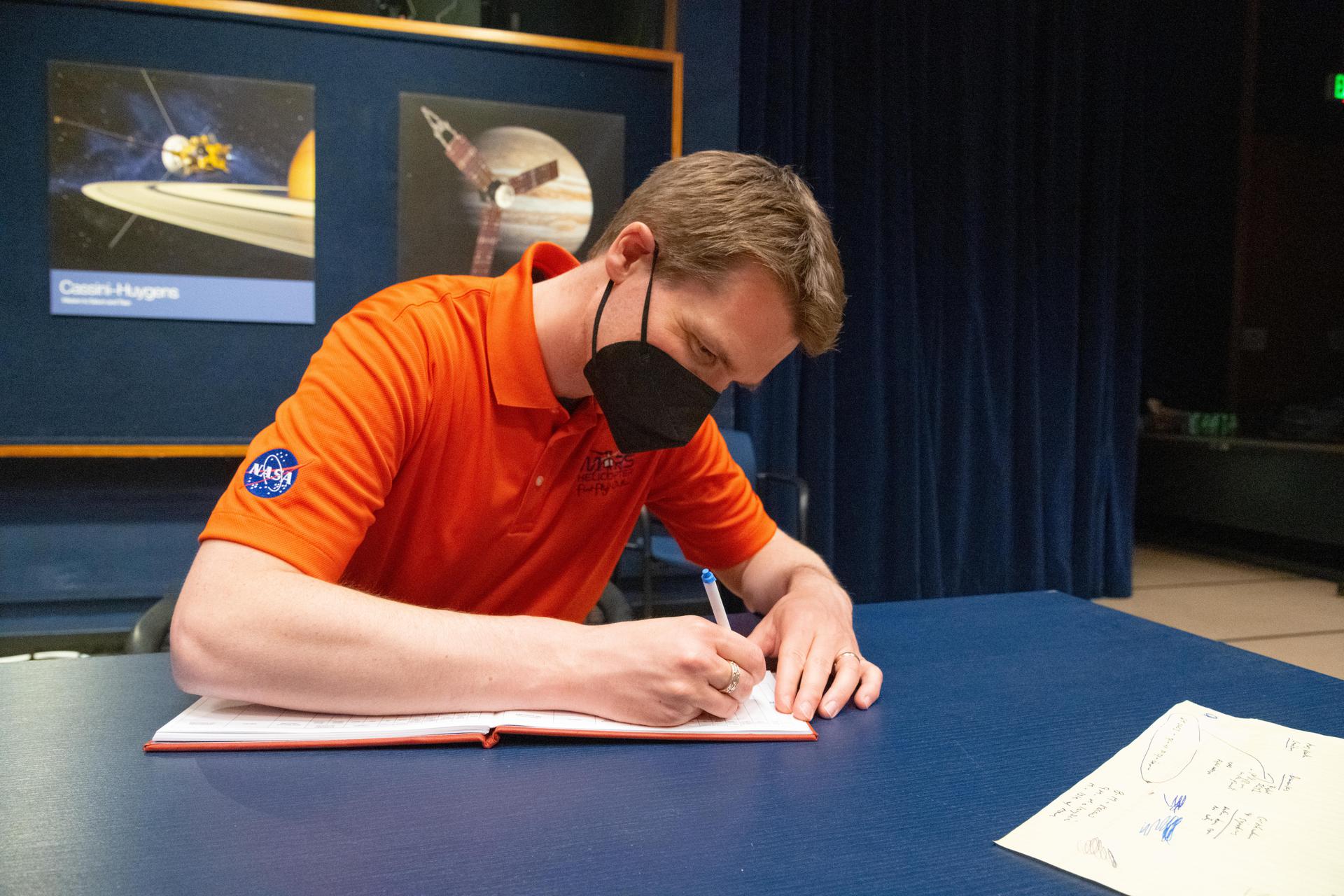 Ingenuity Mars chief pilot Håvard Grip records data of the first flight of the Ingenuity Mars Helicopter into the official pilot's logbook for the project.