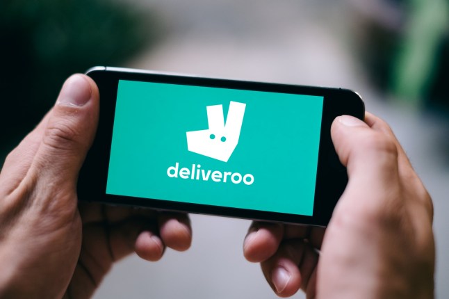 The Deliveroo logo on a phone screen