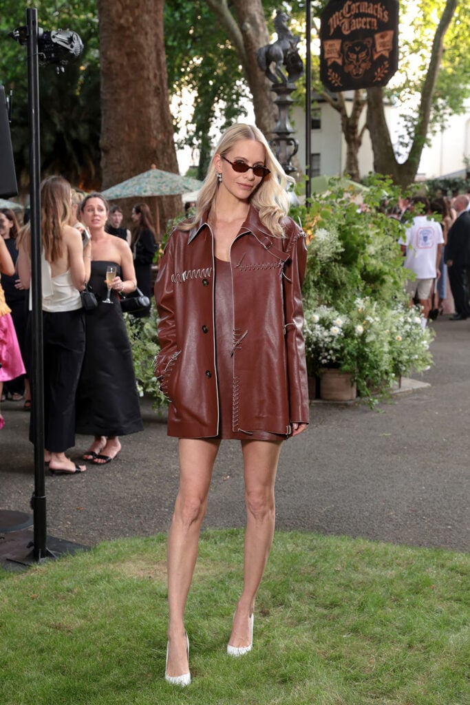 Poppy Delevingne wears Tod's Spring 2026 brown leather dress and matching coat at the Jessica McCormack Summer Solstice Party in London.