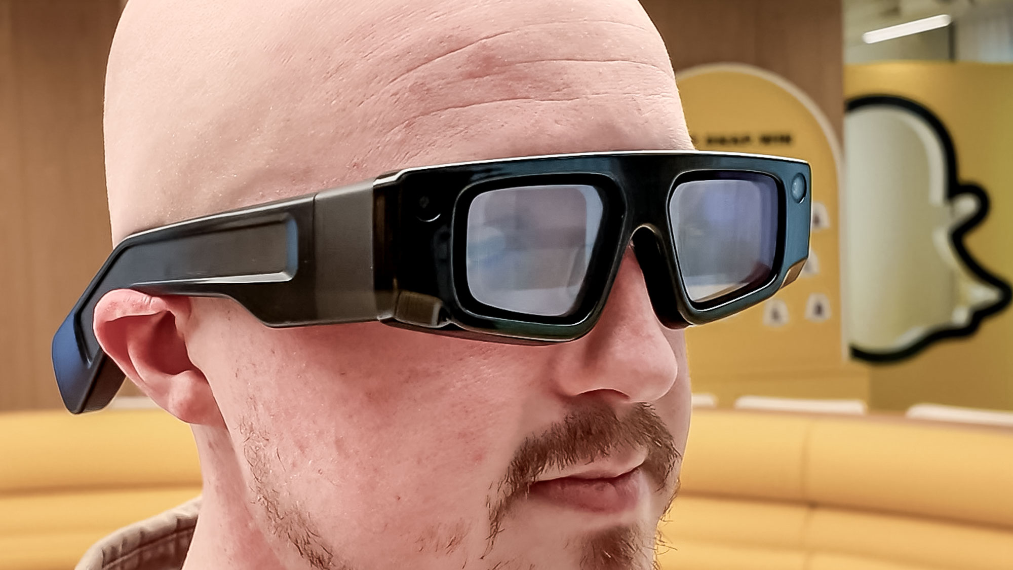 Snapchat Spectacles being worn on person playing around with others in an office space