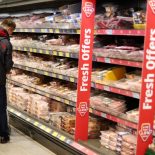 A shopper walks along the meat aisle inside an ALDI supermarket near Altrincham, Britain, February 20, 2023. REUTERS/Phil Noble/