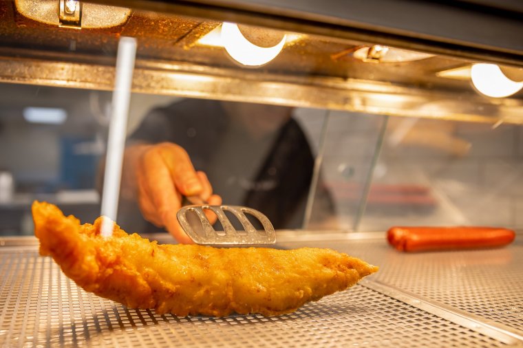 A cooked piece of battered and fried cod in a fish and chips takeaway in London, UK, on Saturday, Sept. 3, 2022. The government has been criticized for waiting until the election of a new Conservative leader before announcing new policies to help families and businesses survive an exceptional rise in global energy prices. Photographer: Betty Laura Zapata/Bloomberg via Getty Images