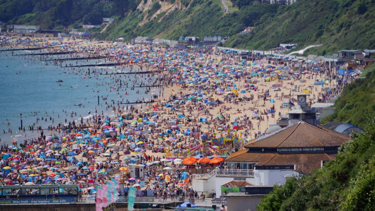 People enjoy the weather on Bournemouth beach in Dorset. England could see the hottest day of the year this weekend as the skies finally clear after weeks of wet and humid weather. Picture date: Saturday July 17, 2021. PA Photo. Photo credit should read: Ben Birchall/PA Wire