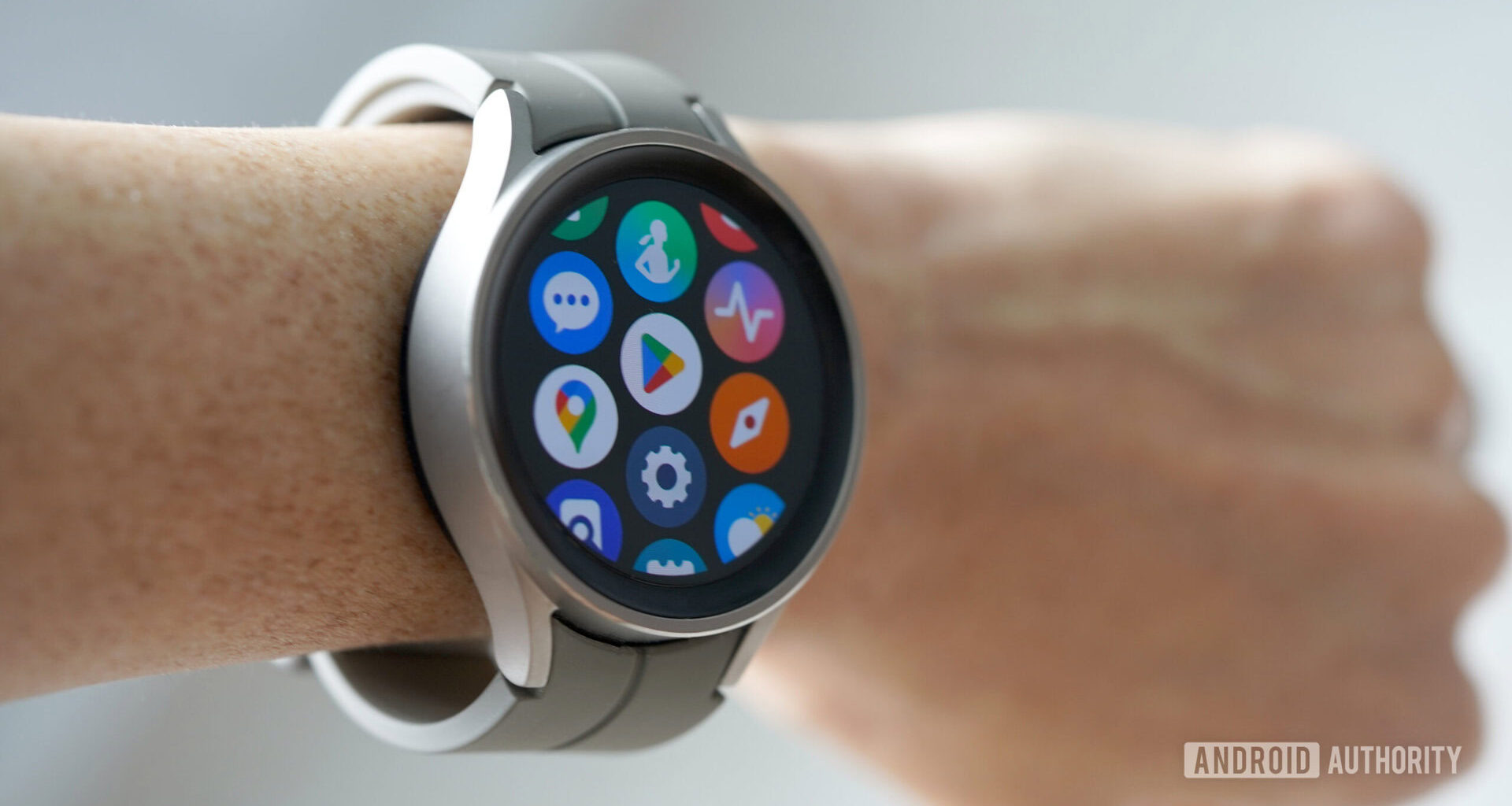 A Samsung Galaxy Watch 5 Pro on a user's wrist displays the app screen.