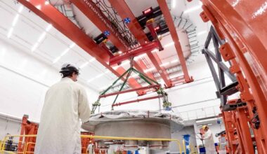 A company outside Boston just craned the second 48-ton half of a steel donut into Tokamak Hall and pushed its compact fusion reactor to 75% built, a machine chasing more energy out of fusion than it puts in by 2027, twelve years before the cathedral-sized ITER in France