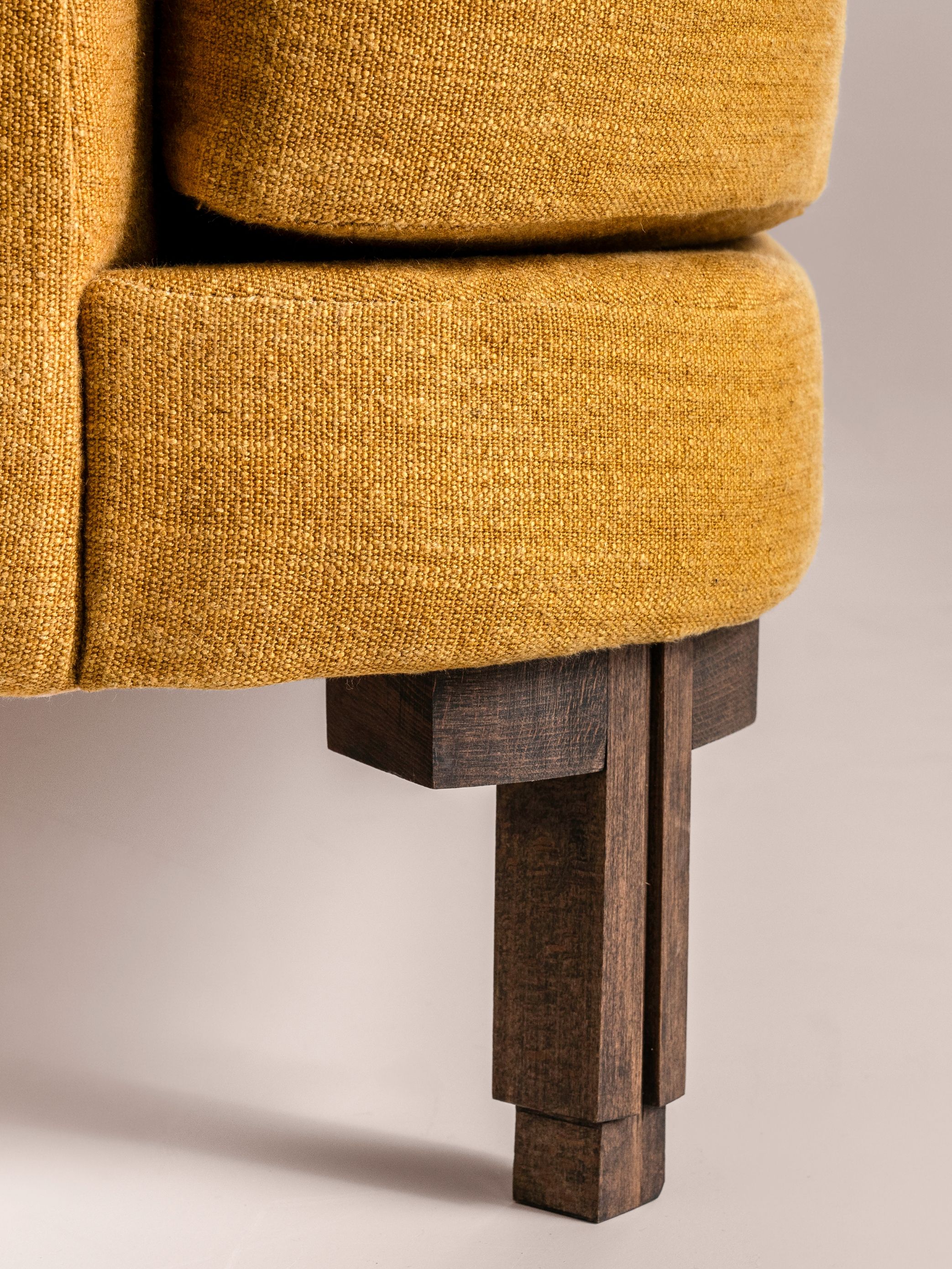 a close up of a wood leg on a yellow chair