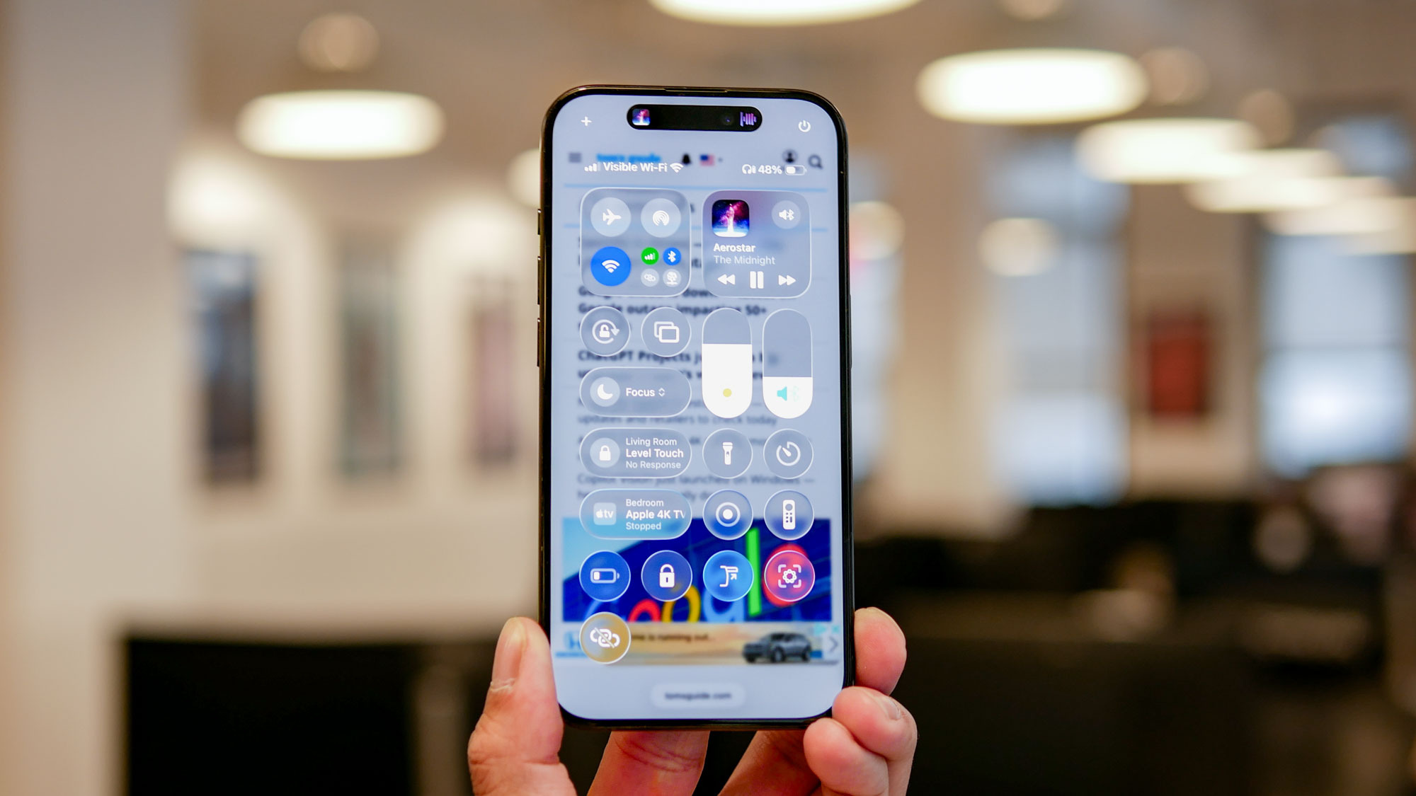 iOS 26 developer beta running on iPhone showing Liquid Glass interface.