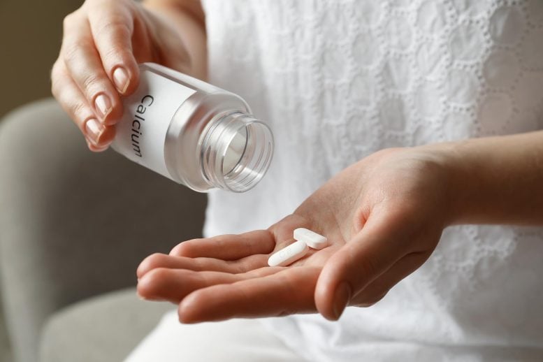 Woman Taking Calcium Supplement Bottle Hand