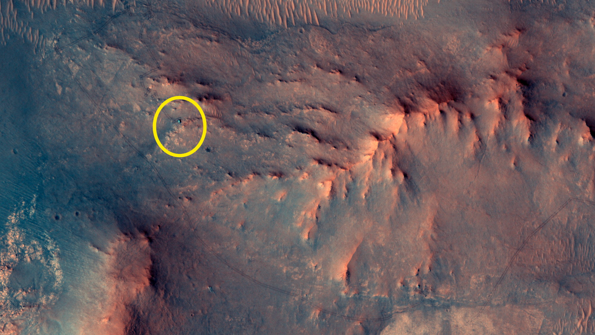 The reddish surface of Mars with a yellow circle indicating the location of Perseverance.