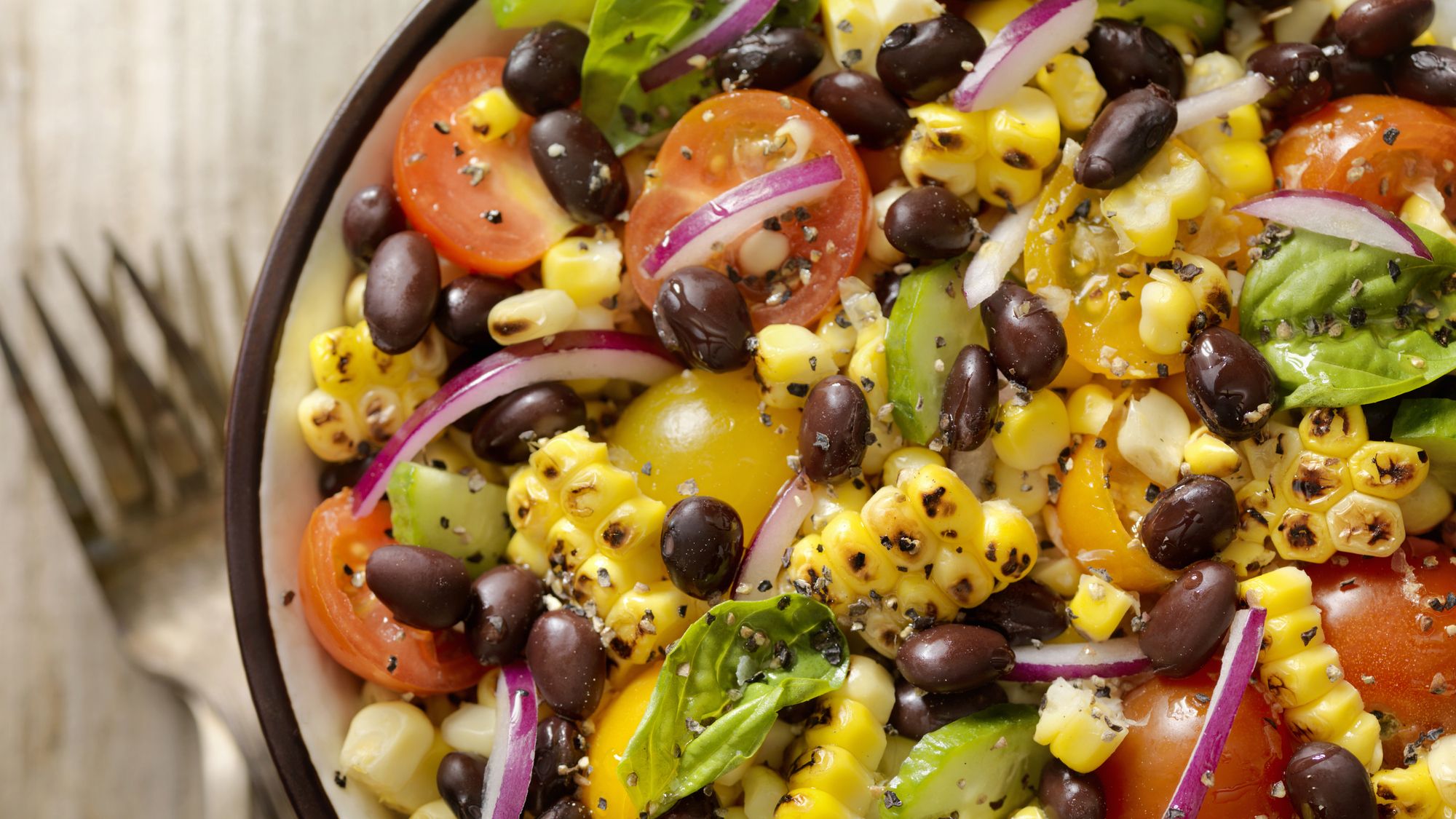 Bowl of salad including black beans and corn