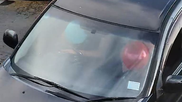 A driver and passenger appearing to inhale nitrous oxide