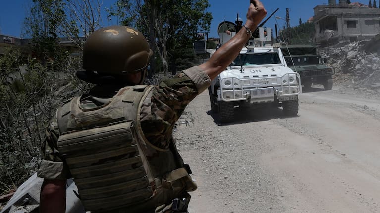 A Lebanese soldier gestures in front of a Spanish UN peacekeeper vehicle Dibbine village, southeast Lebanon, Friday, June 5, 2026, a day after Israeli forces withdrew following clashes with Hezbollah fighters. 