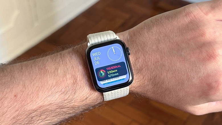 A man's wrist with an Apple Watch displaying the Smart Stack feature