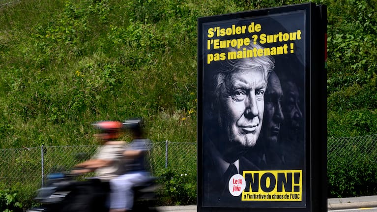 A poster reading "Isolate ourselves from Europe? Certainly not now! - No to the SVP/UDC Chaos initiative" featuring images of President Donald Trump, Russian President Vladimir Putin and Chinese President Xi Jinping.