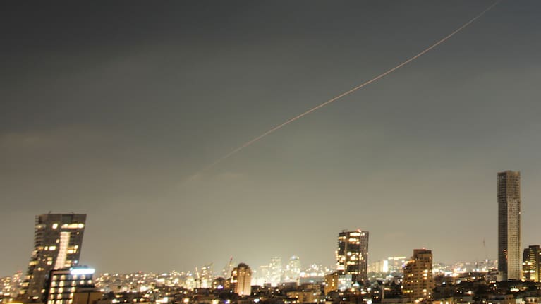 A projectile streaks through the sky over central Israel during an Iranian missile attack, Sunday, June 7, 2026.