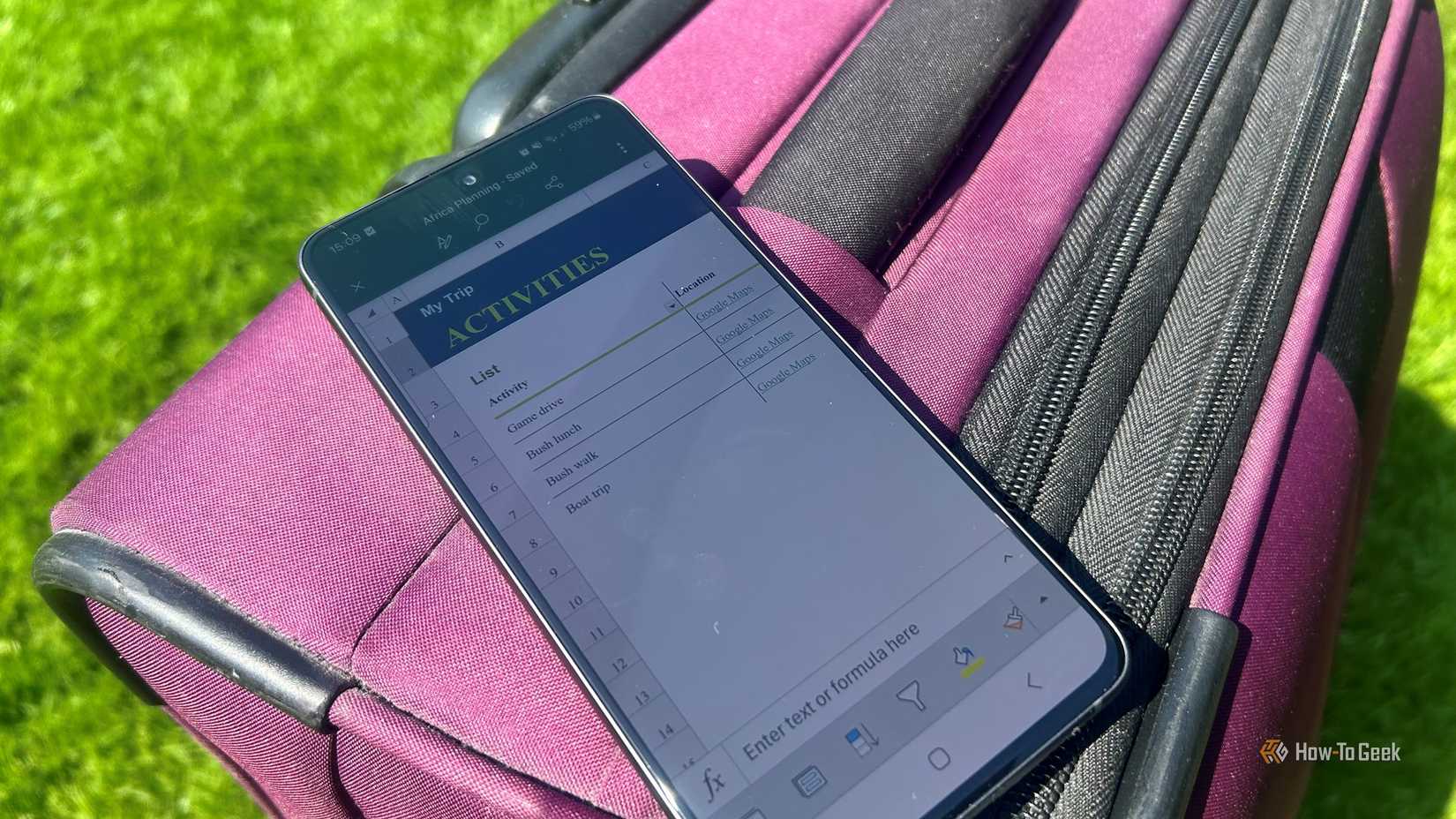 A smartphone displaying the Excel mobile app with a travel workbook open, resting on a suitcase outdoors.